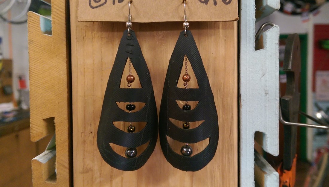 Recycled bike p(art) earrings at Tsunami Cycles in Austin TX. Made by Vie Cycle.